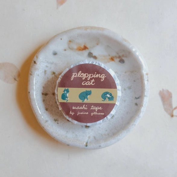Plopping Cat Washi Tape featuring playful blue cat illustrations on a muted beige and maroon background, ideal for Japanese stationery and modern needlework projects.