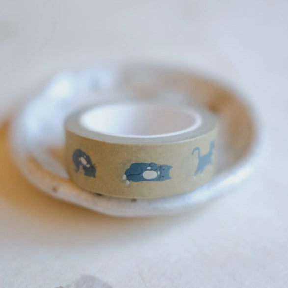 Roll of Plopping Cat Washi Tape featuring cute blue cat illustrations on a muted beige background, perfect for Japanese craft supplies and stationery projects.
