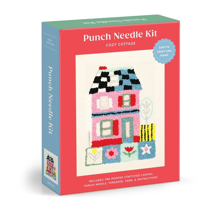 Cozy Cottage Punch Needle Kit featuring a colorful punch needle design of a quaint house with embroidered details on pre-printed stretched canvas, including thread and yarn.