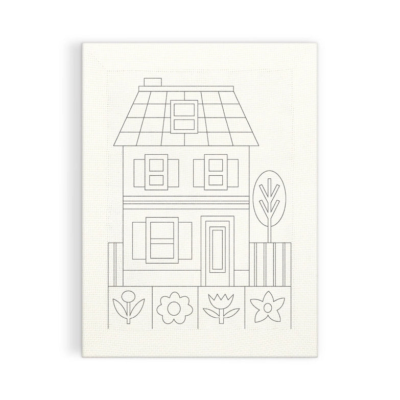 Cozy Cottage Punch Needle Kit featuring a simple line drawing of a two-story house with windows, door, fence, tree, and four stylized flowers on fabric for needlework.
