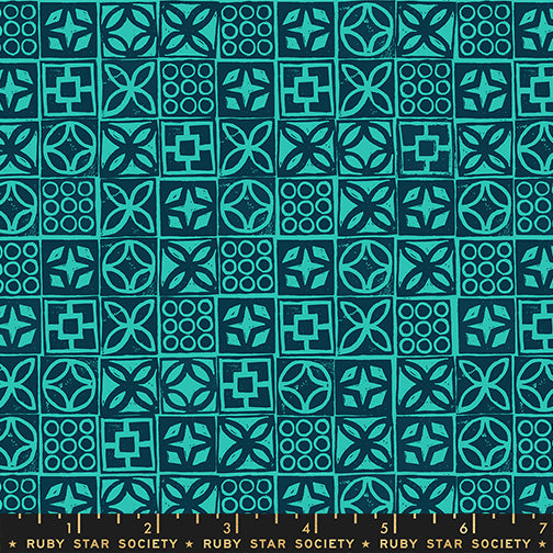 Patterned fabric with geometric designs in teal and black, featuring a ruler at the bottom.