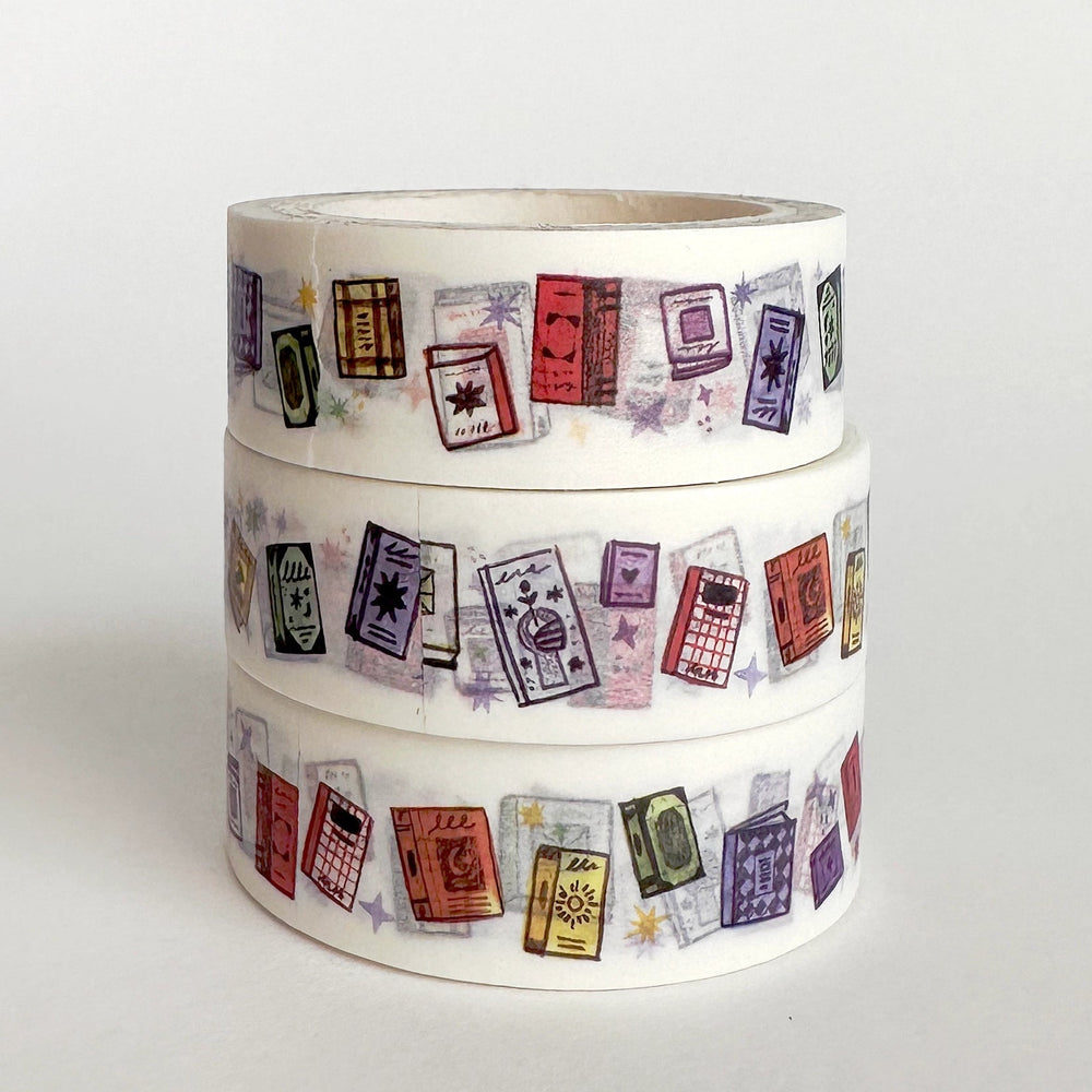 Three rolls of washi tape stacked vertically, featuring a pattern of vintage travel tickets and stamps in various colors on a white background.