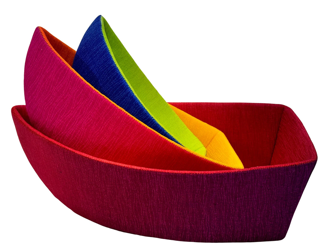 Colorful fabric bowls arranged inside each other in a modern geometric design made using the English Paper Piecing Bowls Pattern - The Dory Boat, featuring vibrant textile craftwork.