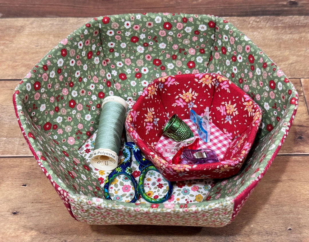 English Paper Piecing Bowls Pattern - The Prosperity Bowl featuring two fabric bowls with floral prints holding sewing supplies including embroidery thread, scissors, and thimbles.