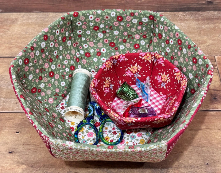 English Paper Piecing Bowls Pattern - The Prosperity Bowl featuring two fabric bowls with floral prints holding sewing supplies including embroidery thread, scissors, and thimbles.