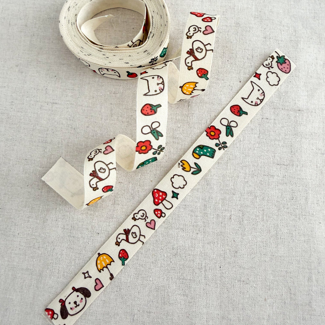 Decorative tape with cartoon designs on a light gray background