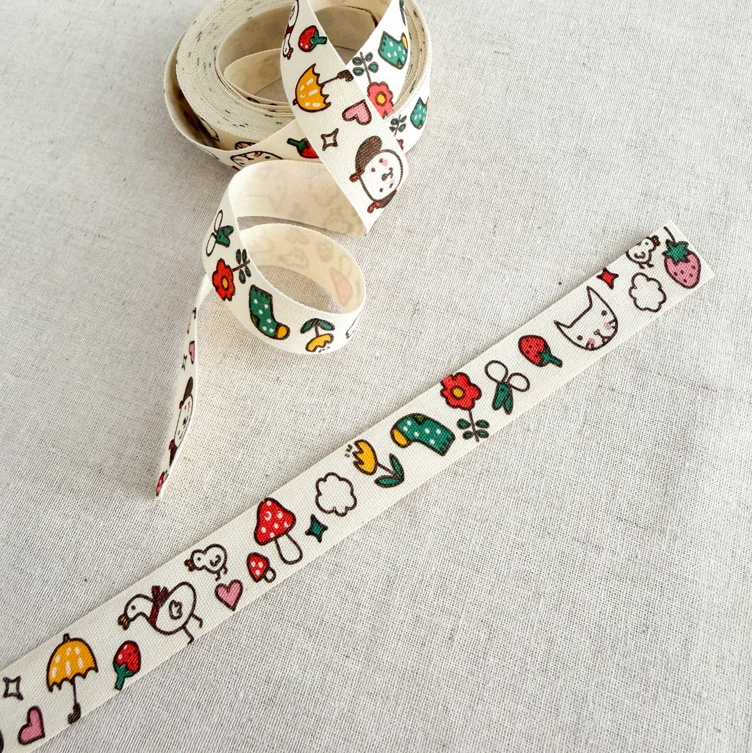 Decorative ribbon with cartoon designs on a light gray background