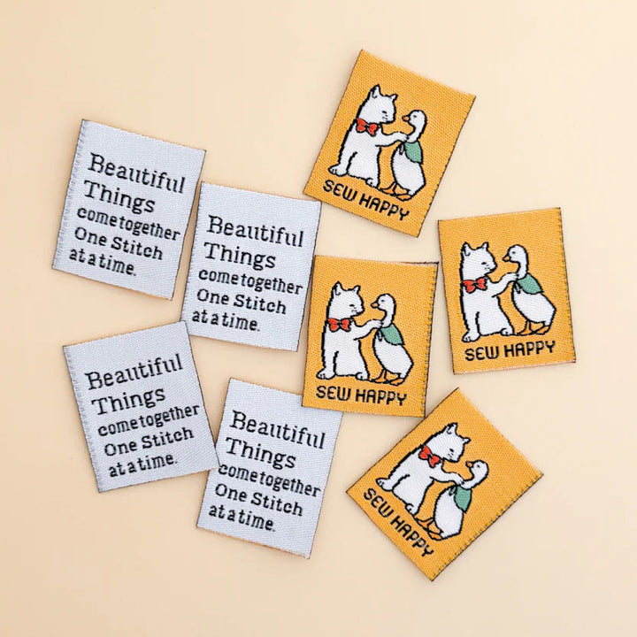 Set of woven labels with cartoon dogs and text on a beige background