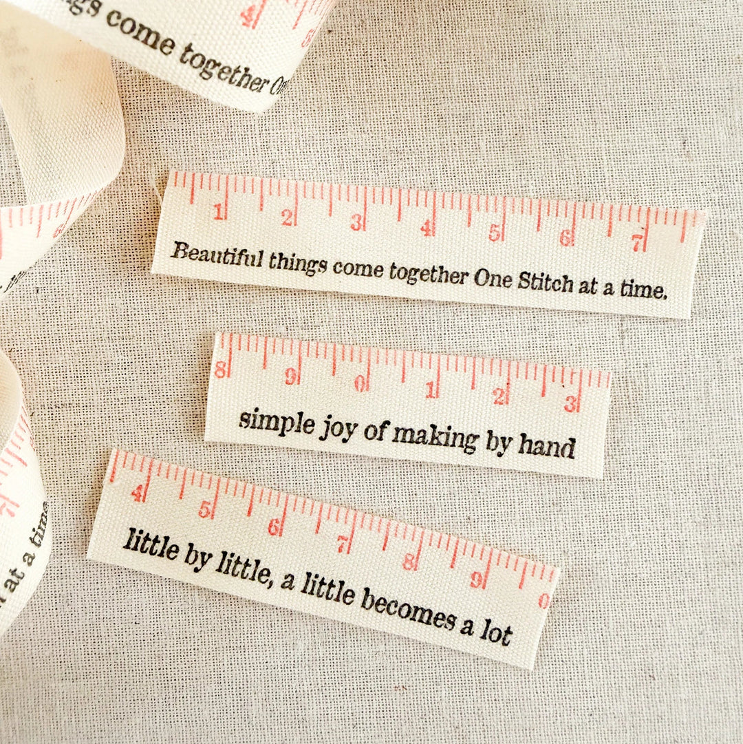 Decorative cotton ribbon with motivational phrases on a textured fabric background