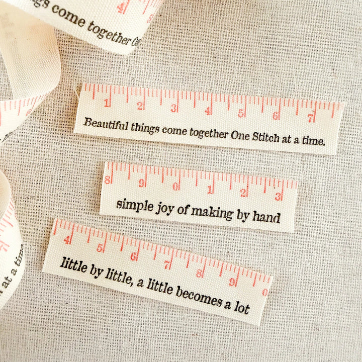 Decorative cotton ribbon with motivational phrases on a textured fabric background