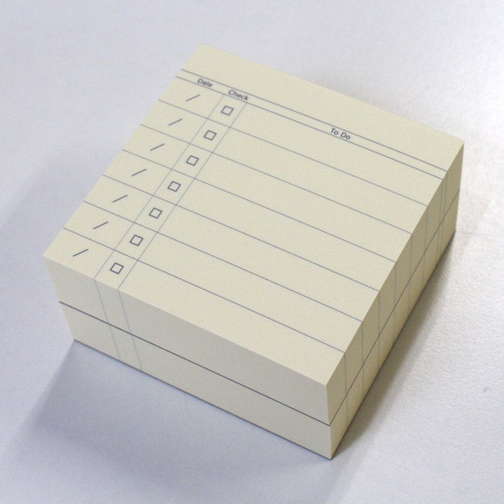 Stack of index cards with checkboxes on a white background