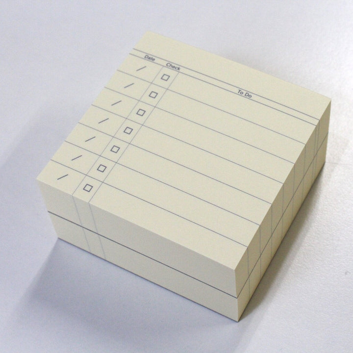 Stack of index cards with checkboxes on a white background