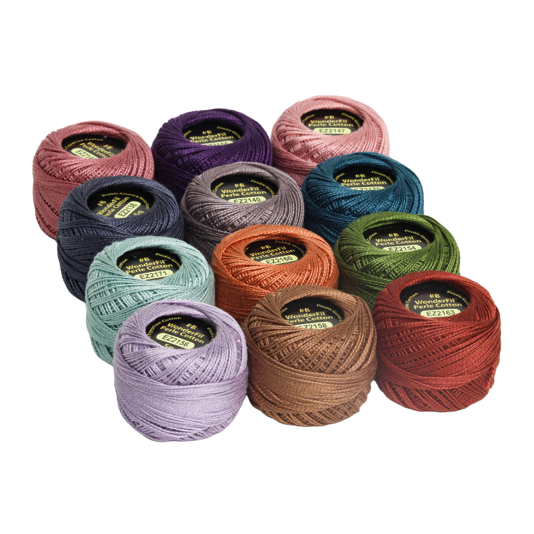 Twelve colorful spools of embroidery thread arranged in a group showcasing a variety of rich shades, featuring the Wonderfil Perle Cotton Set - Vicki McCarty Springtime for needlework and sewing projects.