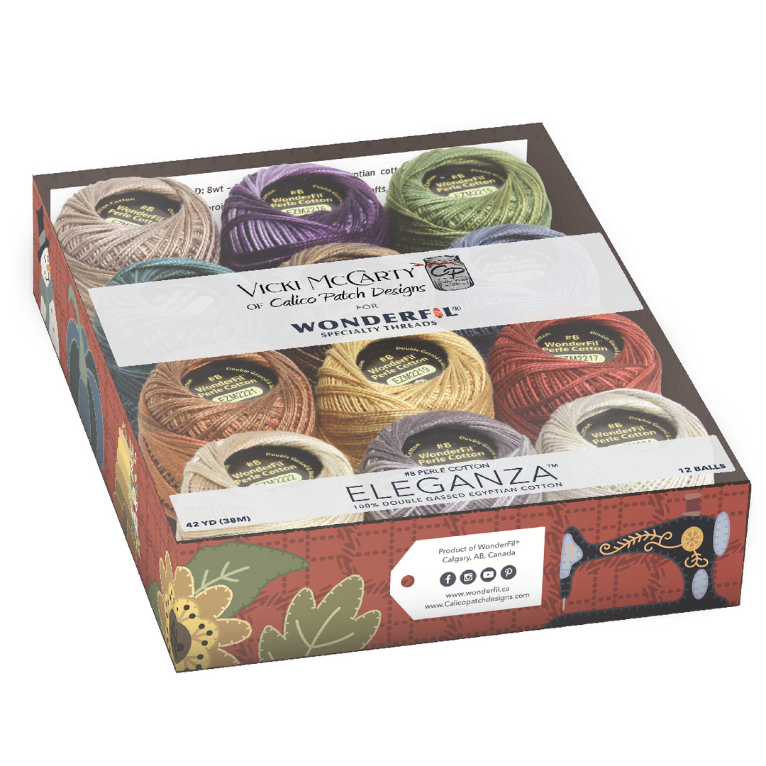 Clear plastic box containing colorful spools of thread in autumnal tones, labeled Wonderfil Perle Cotton Set - Vicki McCarty Variegated, ideal for embroidery and modern needlework projects.