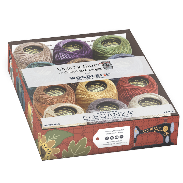 Clear plastic box containing colorful spools of thread in autumnal tones, labeled Wonderfil Perle Cotton Set - Vicki McCarty Variegated, ideal for embroidery and modern needlework projects.