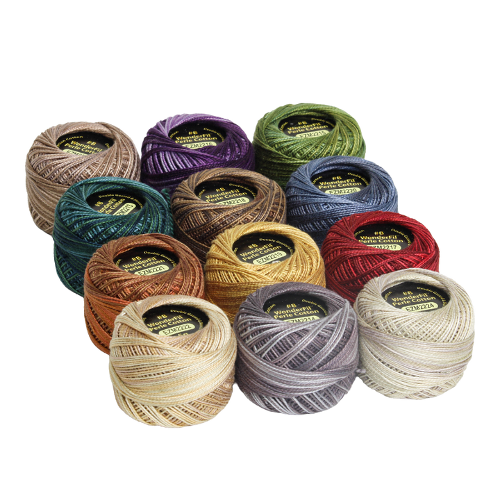 A collection of colorful embroidery threads arranged in a group, showcasing the Wonderfil Perle Cotton Set - Vicki McCarty Variegated, ideal for modern needlework and embroidery projects.