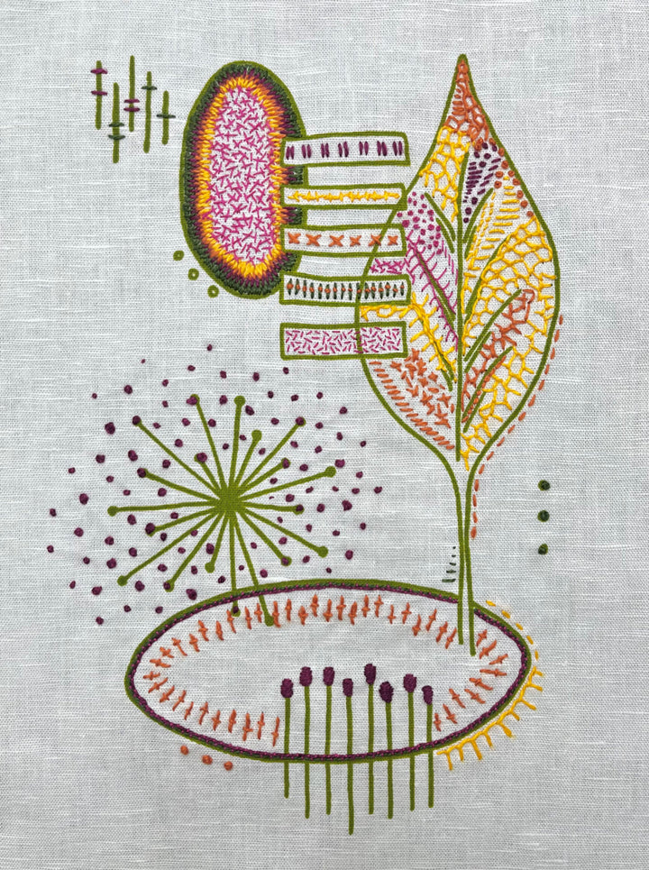 Modern hand embroidery on fabric featuring a colorful abstract leaf and geometric shapes, created using the Freestyle Embroidery Kit - Leaf Print with vibrant threads.