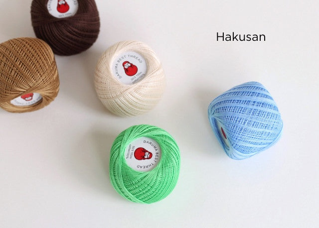 Daruma Home Thread #30 Ball Collections featuring assorted colors of high-quality embroidery thread in brown, tan, cream, green, and blue, ideal for modern needlework and Japanese craft supplies.