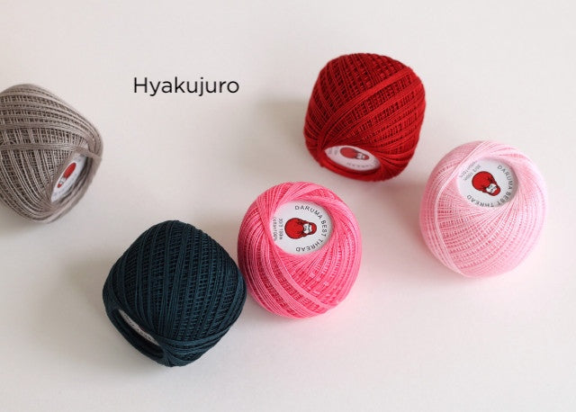 Five colorful balls of Daruma Home Thread #30 Ball Collections embroidery floss in shades of red, pink, navy, and beige, ideal for Japanese craft supplies and modern needlework enthusiasts.