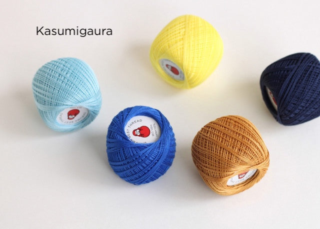 Five colorful balls of Daruma Home Thread #30 Ball Collections embroidery thread in soft yellow, sky blue, navy blue, bright blue, and warm tan shades arranged on a white background for needlework and Japanese craft supplies.